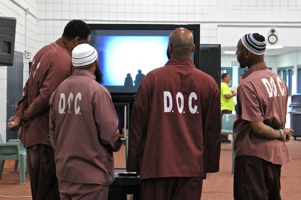 Screen Shot 2019-08-14 at 2.34.40 PM Inmates gather to watch the animated videos they created for 'Hidden Lives Illuminated,' a project of Eastern State Penitentiary. (Emma Lee/WHYY)