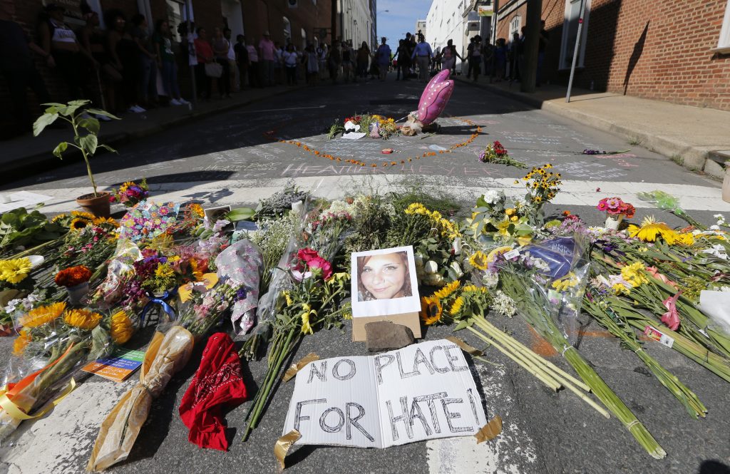 A makeshift memorial of flowers and a photo of victim Heather Heyer sits in Charlottesville, Va., on Aug. 13, 2017. Heyer died when a car rammed into a group of people who were protesting white supremacists who had gathered in the city for a rally. A makeshift memorial of flowers and a photo of victim Heather Heyer sits in Charlottesville, Va., on Aug. 13, 2017. Heyer died when a car rammed into a group of people who were protesting white supremacists who had gathered in the city for a rally. (Steve Helber/AP Photo)