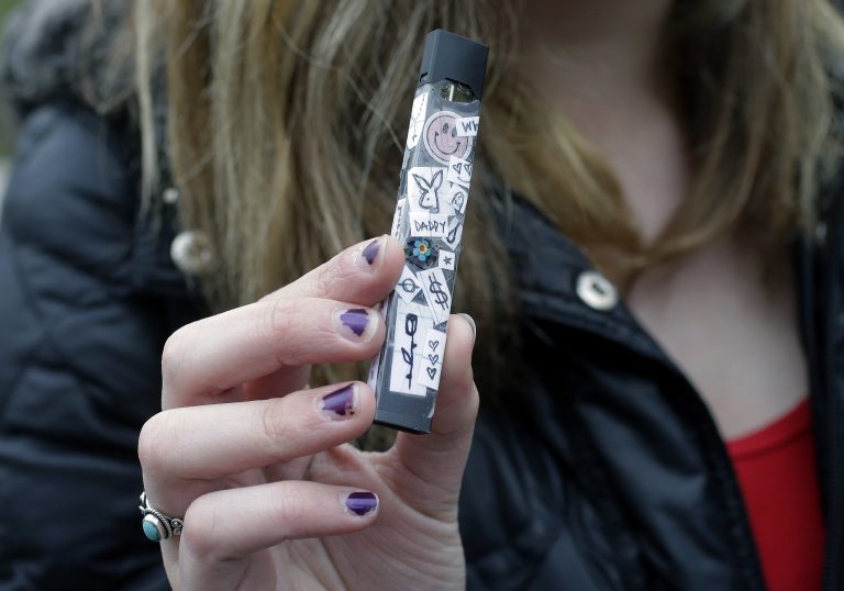 A 15-year-old in Cambridge, Mass., shows off her vaping device in 2018. (Steven Senne/AP Photo)