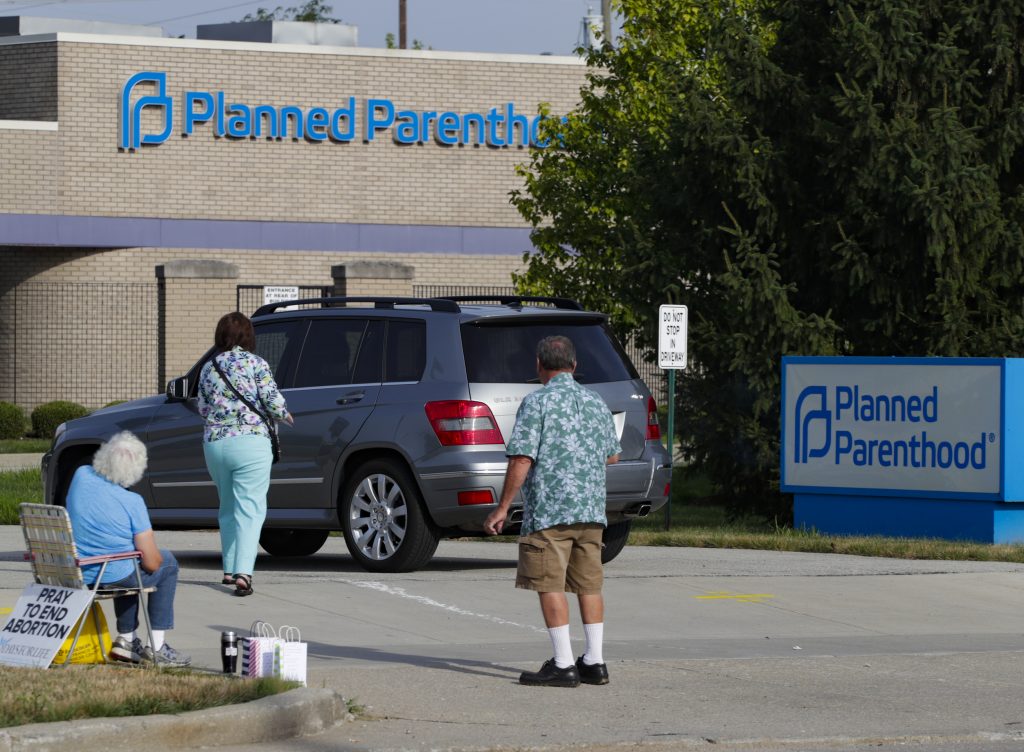 Abortion protesters attempt to hand out literature as they stand in the driveway of a Planned Parenthood clinic in Indianapolis on Aug. 16. Abortion protesters attempt to hand out literature as they stand in the driveway of a Planned Parenthood clinic in Indianapolis on Aug. 16.