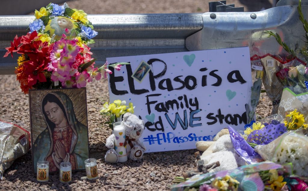 el_paso_shooting_memorial1-e1565082885242-1920×1188 Flowers and a Virgin Mary painting adorn makeshift memorial for the victims of Saturday mass shooting at a shopping complex in El Paso, Texas, Sunday, August 4, 2019. (Andres Leighton/AP Photo)