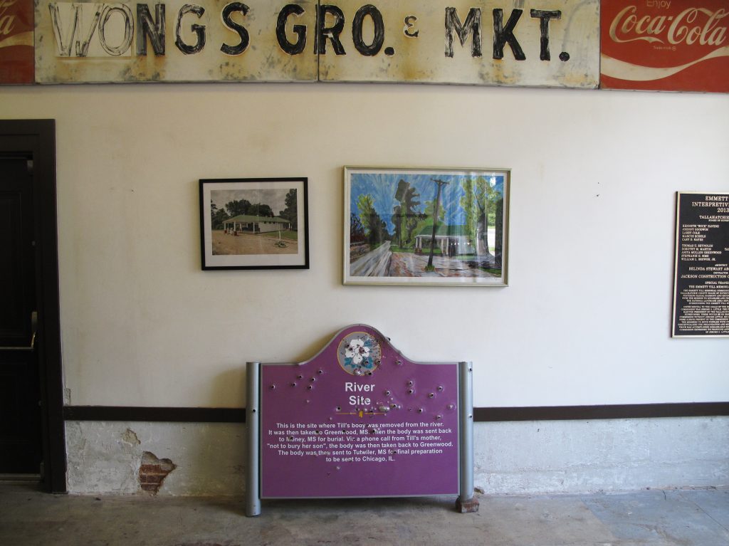 A bullet-riddled sign that once marked where Emmett Till’s body was pulled from the Tallahatchie River is now housed at the Till Interpretive Center in Sumner, Miss. The historic marker was taken down after three white fraternity brothers from the University of Mississippi were pictured holding guns next to the sign. A bullet-riddled sign that once marked where Emmett Till's body was pulled from the Tallahatchie River is now housed at the Till Interpretive Center in Sumner, Miss. The historic marker was taken down after three white fraternity brothers from the University of Mississippi were pictured holding guns next to the sign. (Debbie Elliott/NPR)