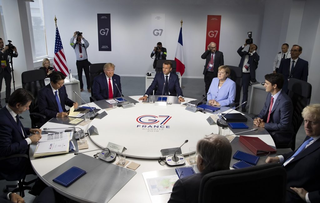 APTOPIX France G7 Summit From the left, Italian Prime Minister, Giuseppe Conte, Japanese Prime Minister Shinzo Abe, U.S President Donald Trump, French President Emmanuel Macron, German Chancellor Angela Merkel, Canadian Prime Minister Justin Trudeau, Britain's Prime Minister Boris Johnson attend a work session during the G7 summit at Casino in Biarritz, southwestern France, Monday Aug.26 2019. G-7 leaders are wrapping up a summit dominated by tensions over U.S. trade policies and a surprise visit by Iran's top diplomat. (Ian Langsdon, Pool via AP)