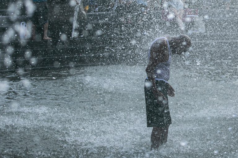 A man cools off in a fountain in New York's Washington Square Park this summer. Death from all causes doubled during a heat wave in New York City in August 1975, with heart attacks and strokes accounting for a majority of the excess deaths. (Jeenah Moon/Bloomberg via Getty Images)