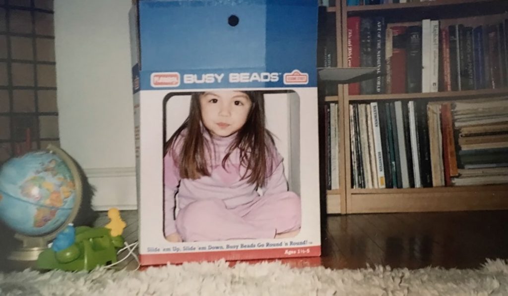 Scanned Documents Liz Tung, at 3 years old, pretends to be on television using a cardboard box. (Image courtesy of Liz Tung)