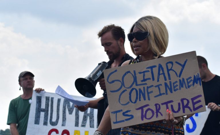 Members of the group Human Rights Coalition speak at a rally Friday, Aug. 2, 2019 at Department of Corrections headquarters in Mechanicsburg, Cumberland County. (Brett Sholtis/WITF)