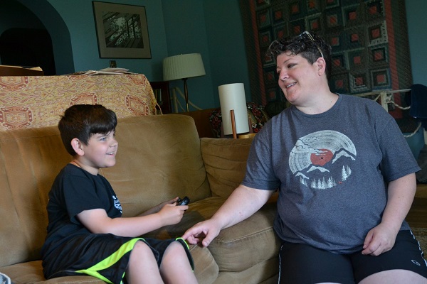 wellspan-phillhaven_family1 Owen Wagner, (left), smiles as he plays Mario Kart next to his mom, Gerren Wagner. Beginning in mid-August, Owen will lose his behavioral services through WellSpan. (Brett Sholtis/Transforming Health)