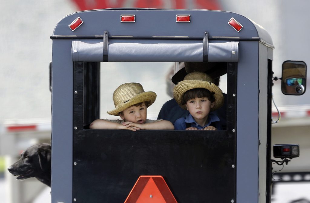 2019 05 29-ap-lancaster county-boys in horse drawn buggy Two boys ride in the back of a horse-drawn buggy stopped at a traffic light, Wednesday, May 29, 2019, in Lancaster County, near Gap, Pa. (AP Photo/Jacqueline Larma)