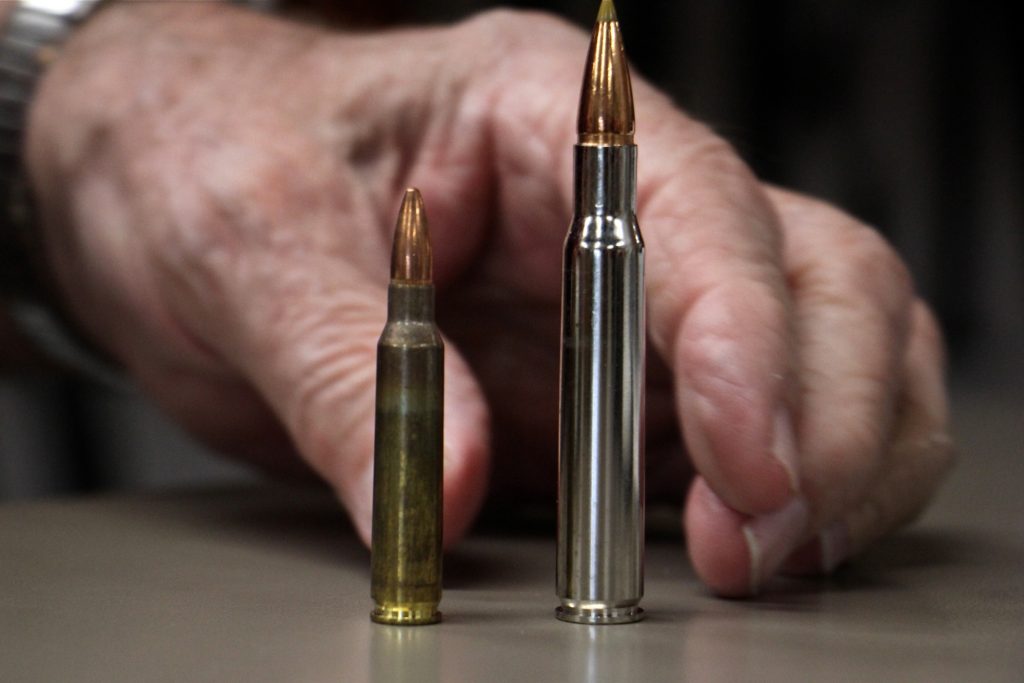 2019 09 04-e lee-glassboro nj bobs little sport shop-ammunition sales bullet comparison Bob Viden, owner of Bob's Little Sport Shop in Glassboro N.J., compares the bullets used in the AR 15 (left) and the Remmington hunting rifle. (Emma Lee/WHYY)