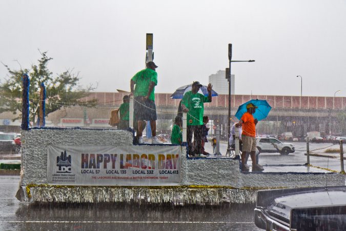 Members of the Laborer’s District Council ride a float down Delaware Ave. at Philadelphia’s 2019 Labor Day Parade. (Kimberly Paynter/WHYY)