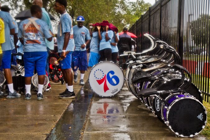 A drum line waits in the downpour to join the 2019 Labor Day Parade. (Kimberly Paynter/WHYY)