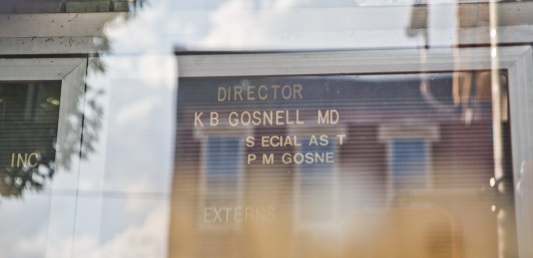 The name of the convicted murderer still adorns the door of the former clinic in West Philadelphia. (Kimberly Paynter/WHYY)