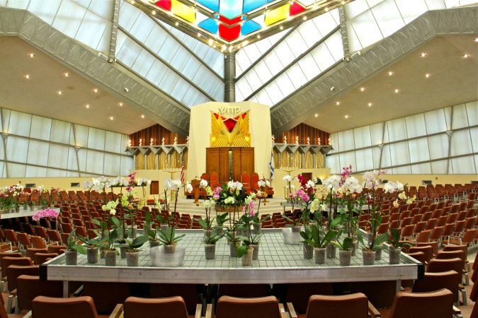Visual artist David Hartt has installed an exhibit at Beth Sholom Synagogue in Elkins Park, designed in the 1950s by architect Frank Lloyd Wright. The exhibit includes tropical plants along with videos, tapestries, and music. (Emma Lee/WHYY)