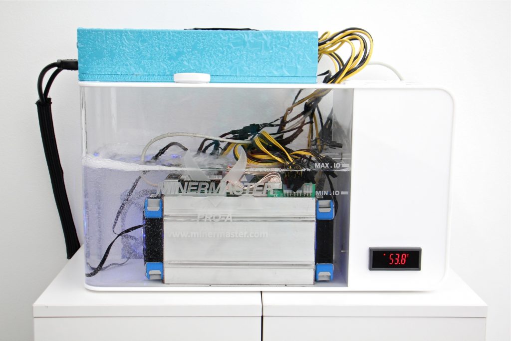 2019 09 12-e lee-upenn annenberg school-cryptocurrency art exhibit A dedicated computer, cooled and quieted by a bath of mineral oil, creates a cryptocurrencey called Auroracoin. It is part of an art exhibit at the Annenberg School of the University of Pennsylvania, 'Making Blockchain in Iceland.' (Emma Lee/WHYY)