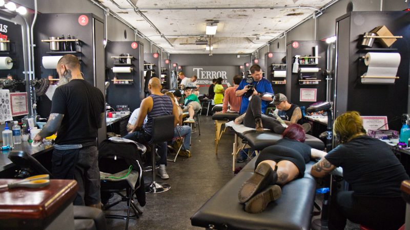 True Hand tattooing company took over the Terror Behind the Walls makeup and effects room to give free classic flash style tattoos to people who waited in line on Friday the 13th. (Kimberly Paynter/WHYY)