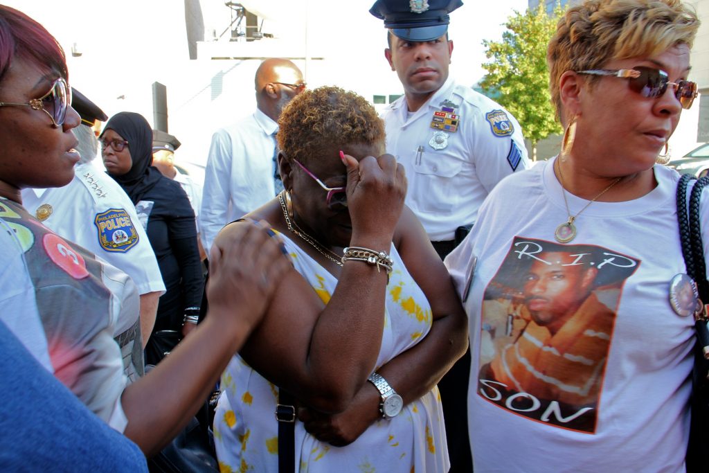2019 09 25-e lee-sonya dixon-philadelphia police station-unsolved homicides demonstration Sonya Dixon (center), whose two grandsons were murdered in 2017 and 2018, weeps during a demonstration outside the Philadelphia Police headquarters to call attention to unsolved murders. (Emma Lee/WHYY)