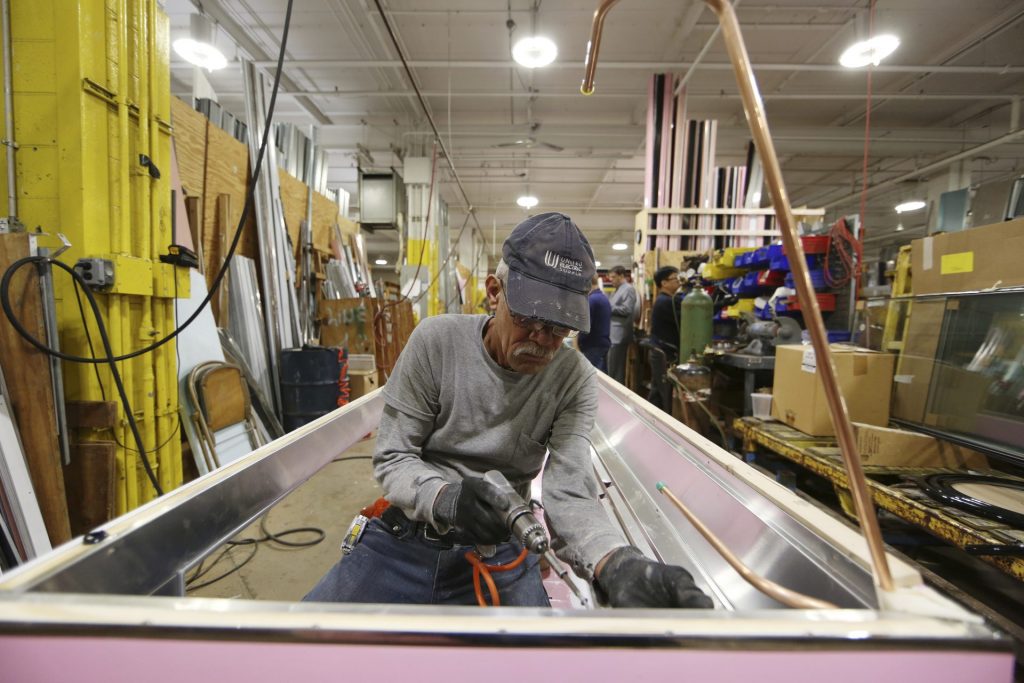 AP_18299748788671-1920×1280 In this Thursday, Oct. 18, 2018, photo Luis Ramos works at the Howard McCray's commercial refrigeration manufacturing facility in Philadelphia. (Matt Rourke/AP Photo)