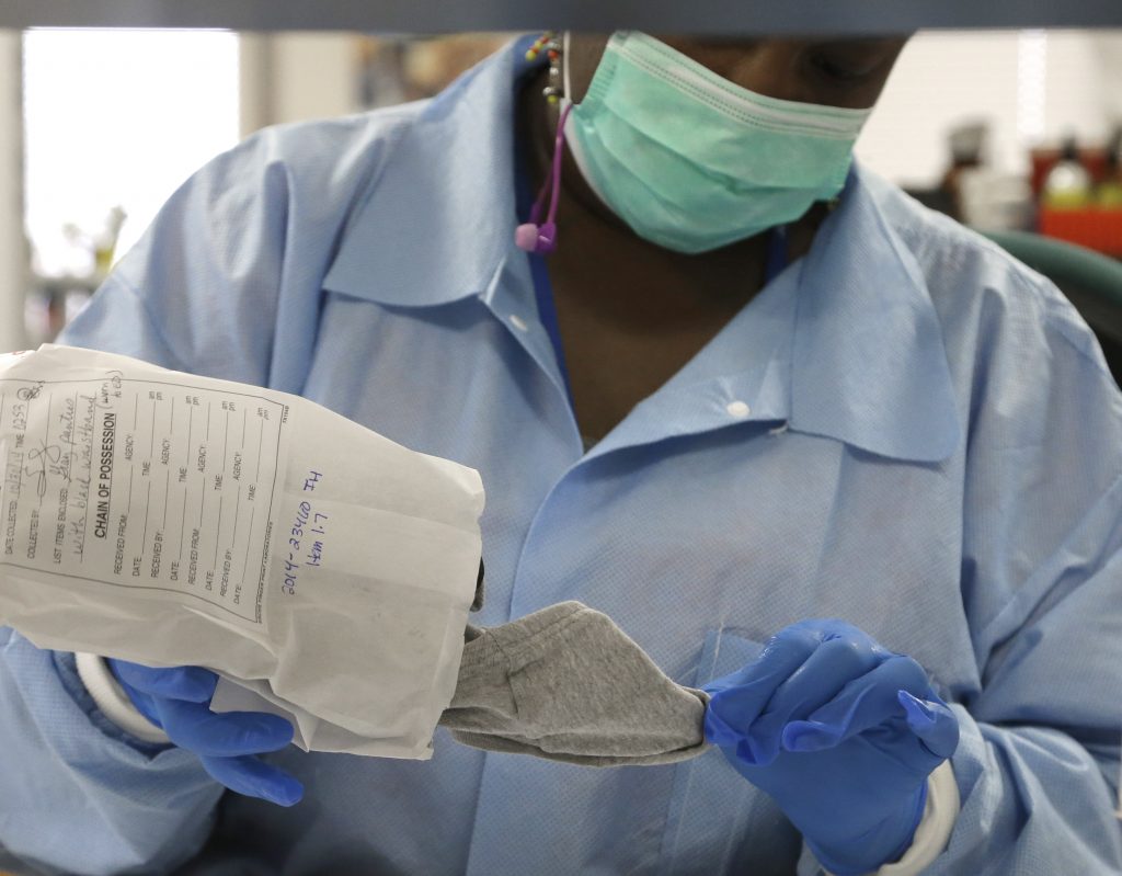 India Henry In this April 2, 2015, file photo, a forensic analyst removes a pair of underwear from an evidence bag for testing in a sexual assault case in the biology lab at the Houston Forensic Science Center in Houston, Texas. (Pat Sullivan/AP Photo, File)
