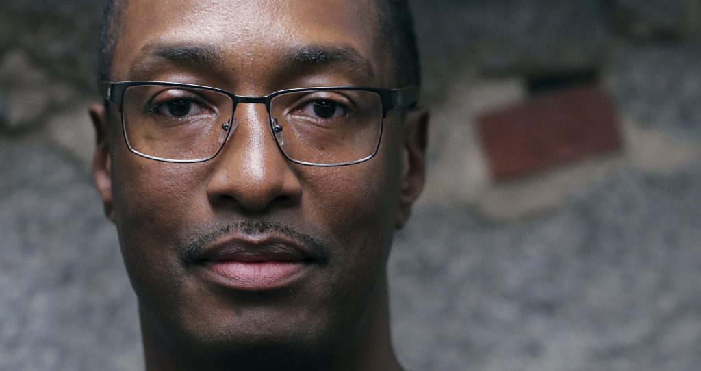 Sean Ellis In this Tuesday June 4, 2019 photograph, Sean Ellis poses for a photo at the law office of his attorney Rosemary Scapicchio in Boston. During the 22 years he spent in prison after being convicted of killing a Boston police detective, Ellis believed there was something suspicious about the officers who led the murder investigation. He just couldn’t prove it. It would take years of digging and scores of public information requests from his attorneys to uncover evidence that several officers investigating the 1993 murder case were involved in criminal activity, information that wasn’t shared with the defense. (Charles Krupa/AP Photo)