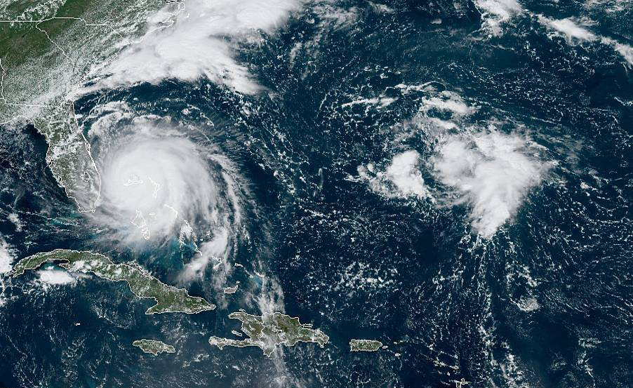 Tropical Weather This GOES-16 satellite image taken Monday, Sept. 2, 2019, at 16:40 UTC and provided by National Oceanic and Atmospheric Administration (NOAA), shows Hurricane Dorian, (left), churning over Bahamas. Hurricane Dorian hovered over the Bahamas on Monday, pummeling the islands with a fearsome Category 4 assault that forced even rescue crews to take shelter until the onslaught passes. (NOAA via AP)