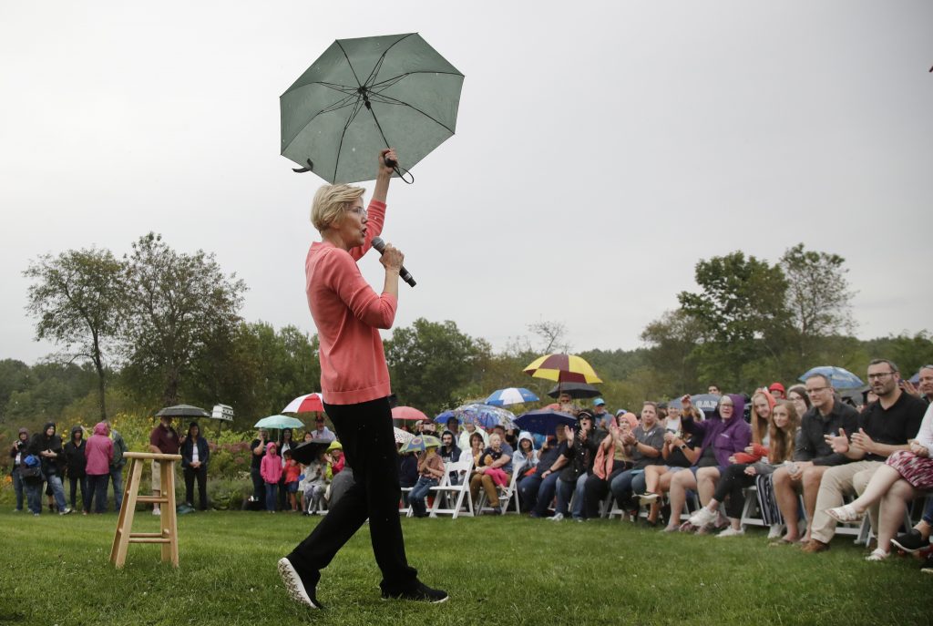 Elizabeth Warren Democratic presidential candidate Sen. Elizabeth Warren, D-Mass., gestures with an umbrella as she speaks at a campaign event, Monday, Sept. 2, 2019, in Hampton Falls, N.H. (AP Photo/Elise Amendola)