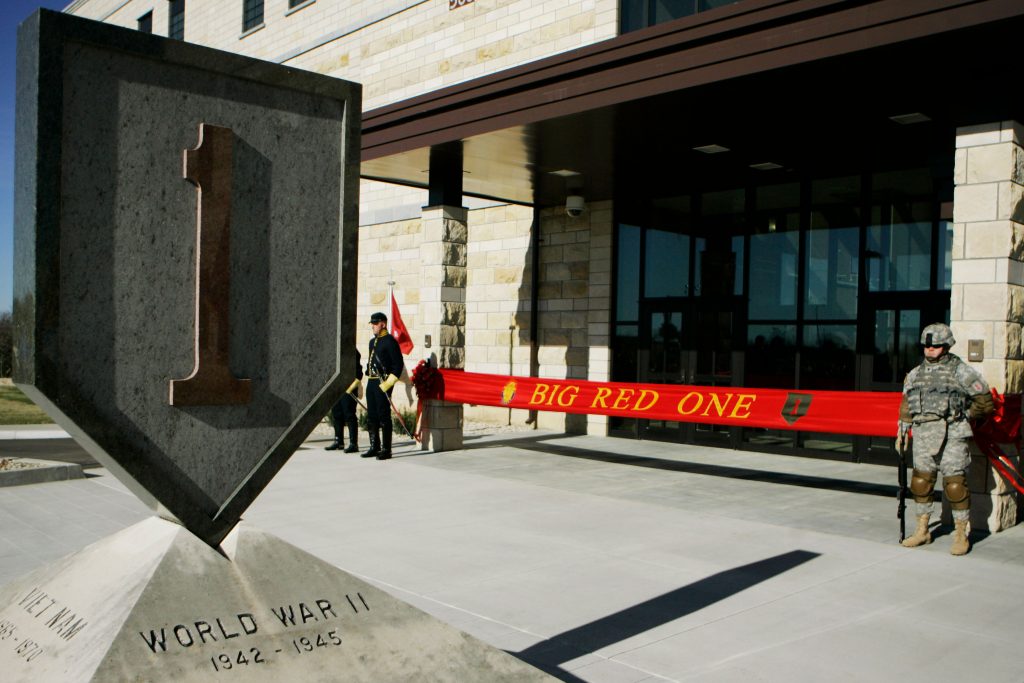 AP_19266662244827 In this Feb. 9, 2015 file photo, an honor guard stands at the entrance before ribbon cutting ceremonies for the new 1st Infantry Division Headquarters at Fort Riley, Kan. Prosecutors say a U.S. Army infantry soldier stationed at Fort Riley shared bomb-making instructions online and also discussed killing activists and bombing a news network. The Justice Department says Monday, Sept. 23, 2019, that private first class Jarrett William Smith was charged with distributing information related to explosives and weapons of mass destruction. (AP Photo/Orlin Wagner File)