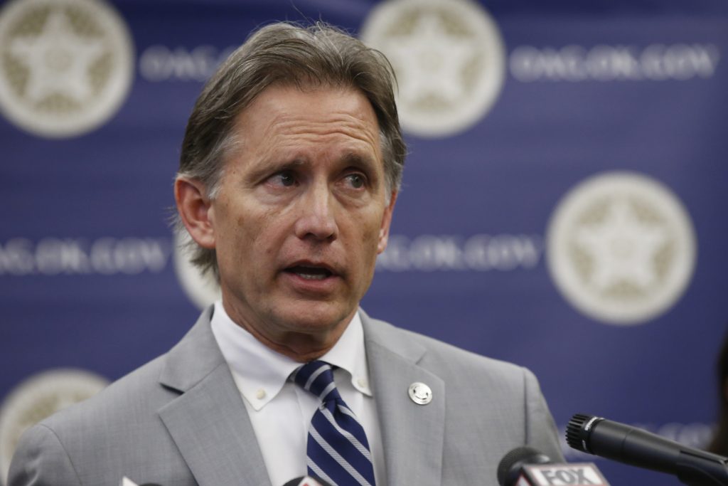 Mike Hunter In this Thursday, Sept. 12, 2019 file photo, Oklahoma Attorney General Mike Hunter speaks during a news conference in Oklahoma City. Consumer products giant Johnson & Johnson is appealing an Oklahoma judge's $572 million order against the company and its subsidiaries for helping fuel the state's opioid crisis. (Sue Ogrocki/AP Photo, File)