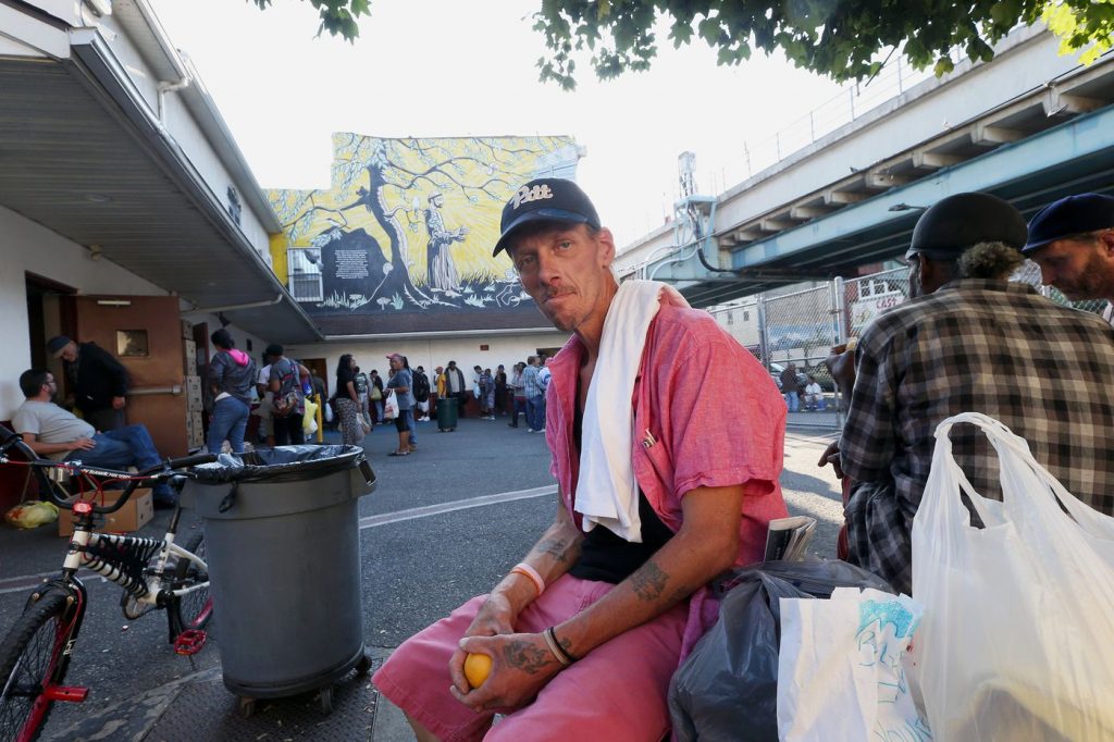 Russell Hadlock, 49, sits outside the St. Francis Inn, a soup kitchen for low-income and homeless people, in Philadelphia's Kensington section on Wednesday. (Stephen M. Falk/The Philadelphia Inquirer)