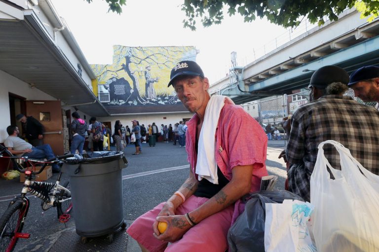 Russell Hadlock, 49, sits outside the St. Francis Inn, a soup kitchen for low-income and homeless people, in Philadelphia's Kensington section on Wednesday. (Stephen M. Falk/The Philadelphia Inquirer)