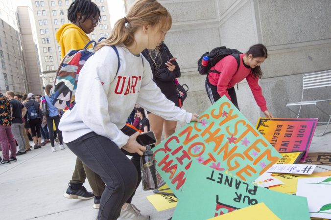 Protesters select signs on the north side of City Hall (Jonathan Wilson for WHYY)