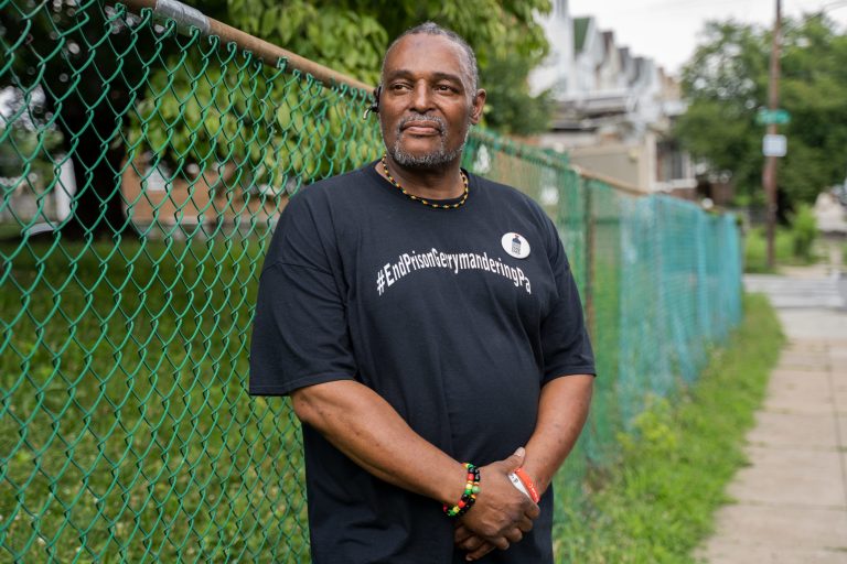 Atiba Kwesi, 59, of Overbrook in West Philadelphia poses for a portrait outside of Fellowship Christian Church wearing a shirt reading 