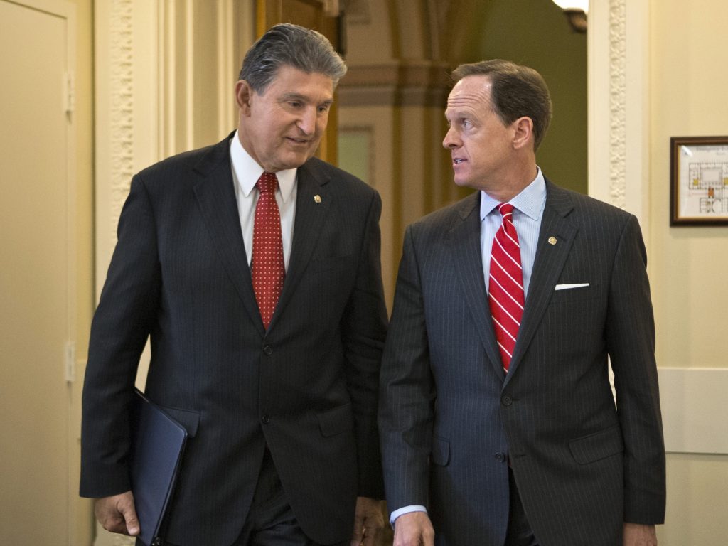 Gun Control Congress In this April 10, 2013 file photo, Sen. Joe Manchin, D-W.Va. (left) and Sen. Patrick Toomey, R-Pa. arrive for a news conference on Capitol Hill in Washington to announce that they have reached a bipartisan deal on expanding background checks to more gun buyers. (AP Photo/J. Scott Applewhite, File)