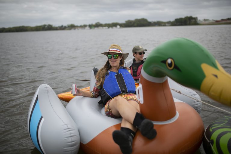 Erica Baugh of Upstream Alliance floats on the Delaware River in Pyne  Poynt Park in Camden, N.J. (Miguel Martinez for WHYY)