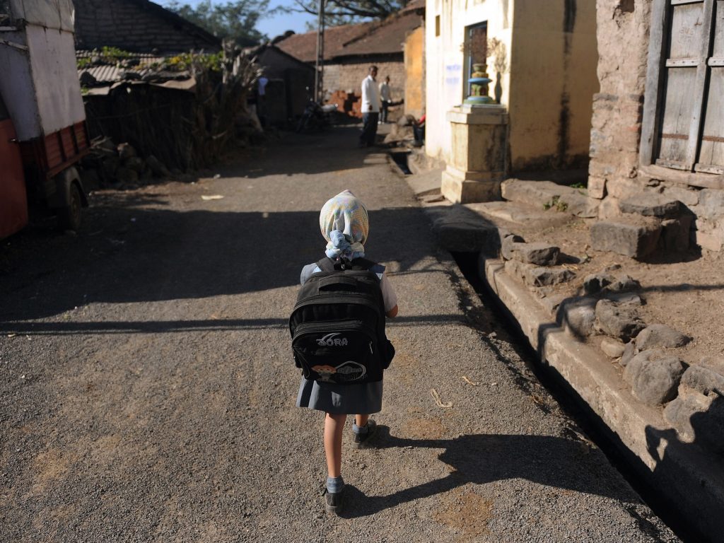 A child leaves for school in a village in India. Last November, the Indian government announced new rules limiting the weight of school bags depending on a child’s age. But the rules are not always enforced. A child leaves for school in a village in India. Last November, the Indian government announced new rules limiting the weight of school bags depending on a child's age. But the rules are not always enforced. (Punit Paranjpe /AFP/Getty Images)