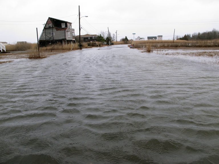 This March 14, 2017, photo shows the flooded streets of a back bay neighborhood in Manahawkin N.J., after a moderate storm. (AP Photo/Wayne Parry)