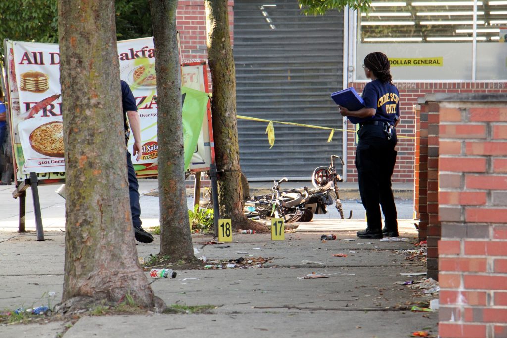 2018 10 03-e lee-philadelphia germantown dollar general-drive by shooting gun violence Police investigate a 2018 drive-by shooting in Germantown. The City’s Controller has found that a homicide reduces the values of a nearby homes. (Emma Lee/WHYY)