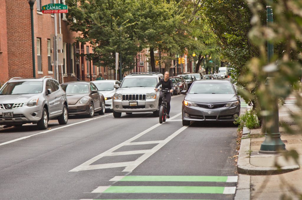 2019-09-30-kpaynter-vision-zero-report-7 A cyclist rides down a bike lane in Philadelphia