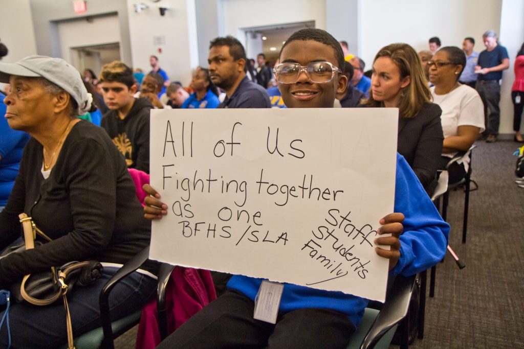 2019 10 07 k paynter school abestos meeting-3 Maurice Boston, a freshman at Ben Franklin H.S., shows his support at a packed meeting discussing the closures of Ben Franklin and Science Leadership Academy high schools because of asbestos remediation at the school district building Monday morning. (Kimberly Paynter/WHYY)