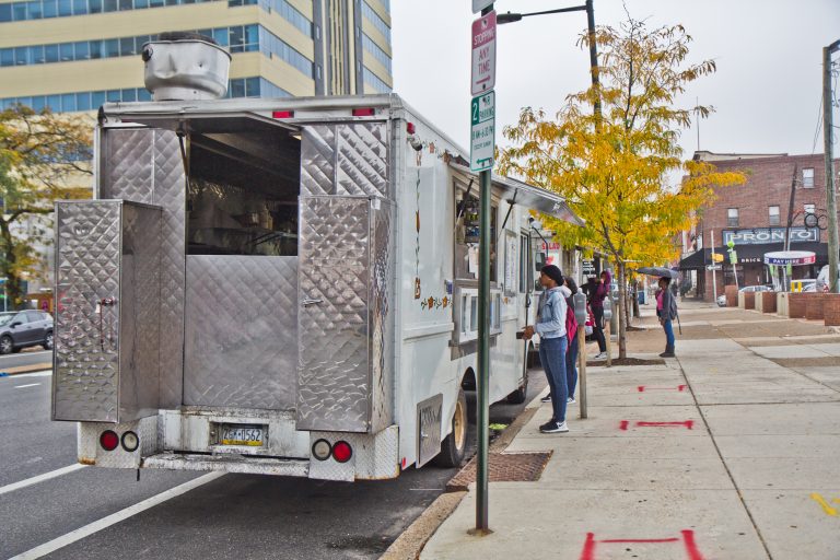 Food trucks lined up on the street.