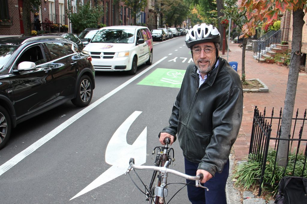 2019 10 25-e lee-larry spector-philadelphia pine and spruce street bike lanes-delineator posts Larry Spector, president of the Society Hill Civic Association, hops off his bike at 5th and Pine streets. (Emma Lee/WHYY)