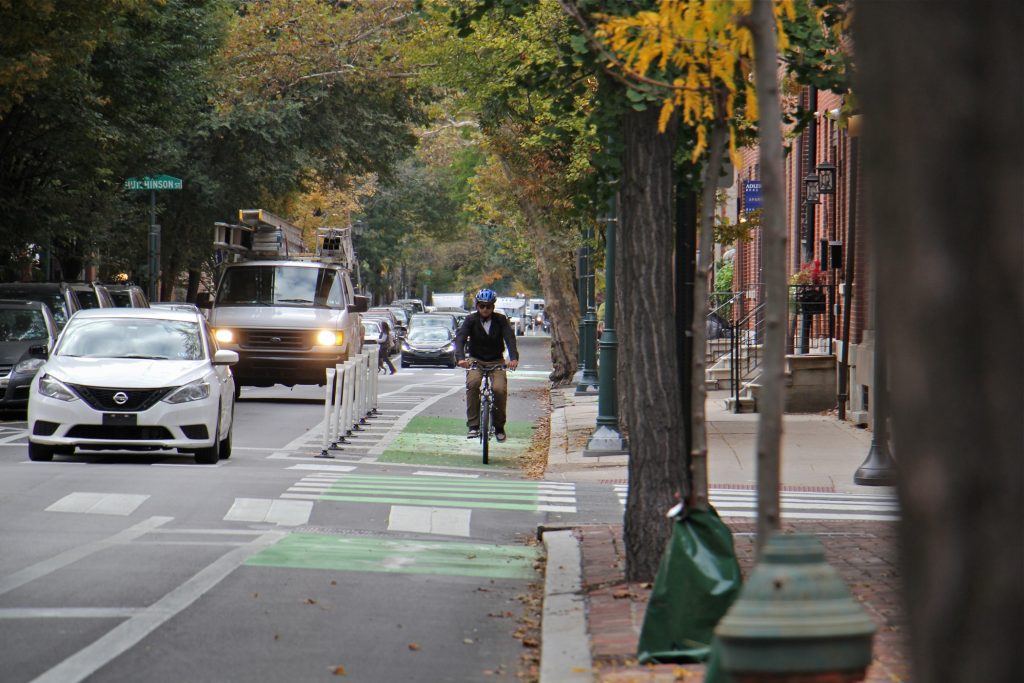 2019 10 25-e lee-philadelphia pine and spruce street bike lanes-delineator posts Delineator posts protect a cyclist at Pine and 9th streets. (Emma Lee/WHYY)