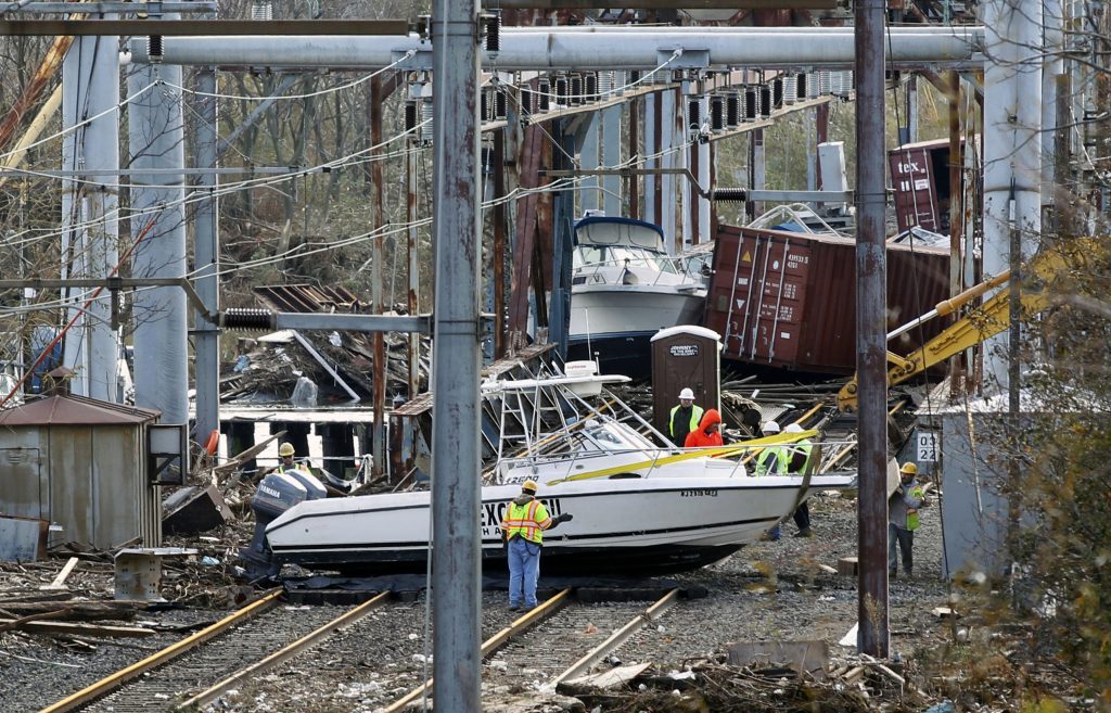 Superstorm Rail Power Station In this Oct. 31, 2012 file photo, workers try to clear boats and debris from the New Jersey Transit's Morgan draw bridge after surge from Sandy pushed boats and cargo containers onto the train tracks. (Mel Evans/AP Photo, File)