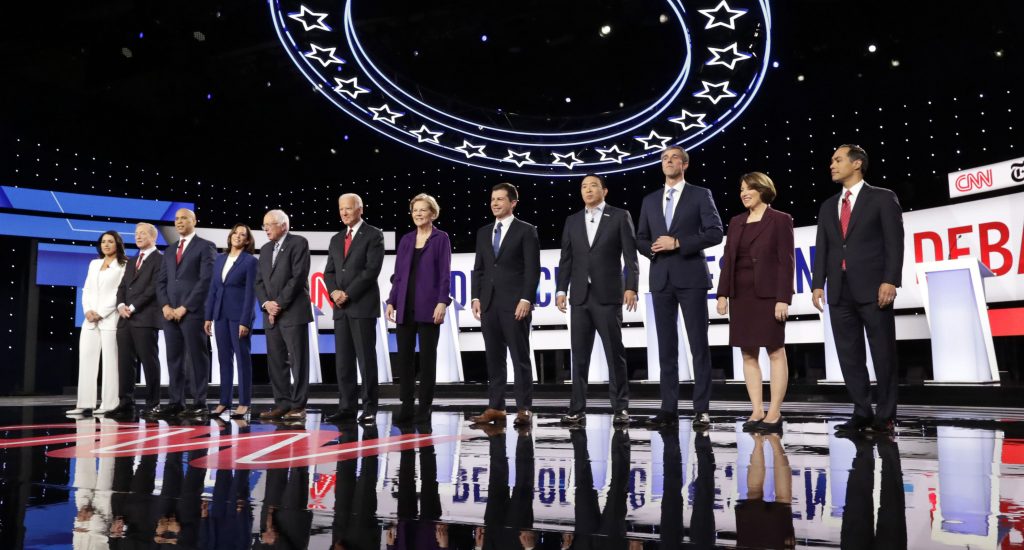 Tulsi Gabbard, Tom Steyer, Cory Booker, Kamala Harris, Bernie Sanders, Joe Biden, Elizabeth Warren, Pete Buttigieg, Andrew Yang, Beto O’Rourke, Amy Klobuchar, Julian Castro Democratic presidential candidates stand on stage for a photo before a primary debate hosted by CNN and The New York Times at Otterbein University, Tuesday, Oct. 15, 2019, in Westerville, Ohio. (Tony Dejak/AP Photo)