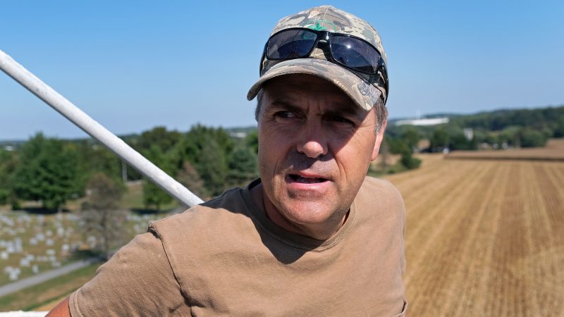 Grain farmer Don Cairns looks out over land he farms while atop a grain silo Sept. 25, 2019, at Cairns Family Farm in Sadsbury Township, Pennsylvania. (Matt Smith for Keystone Crossroads)