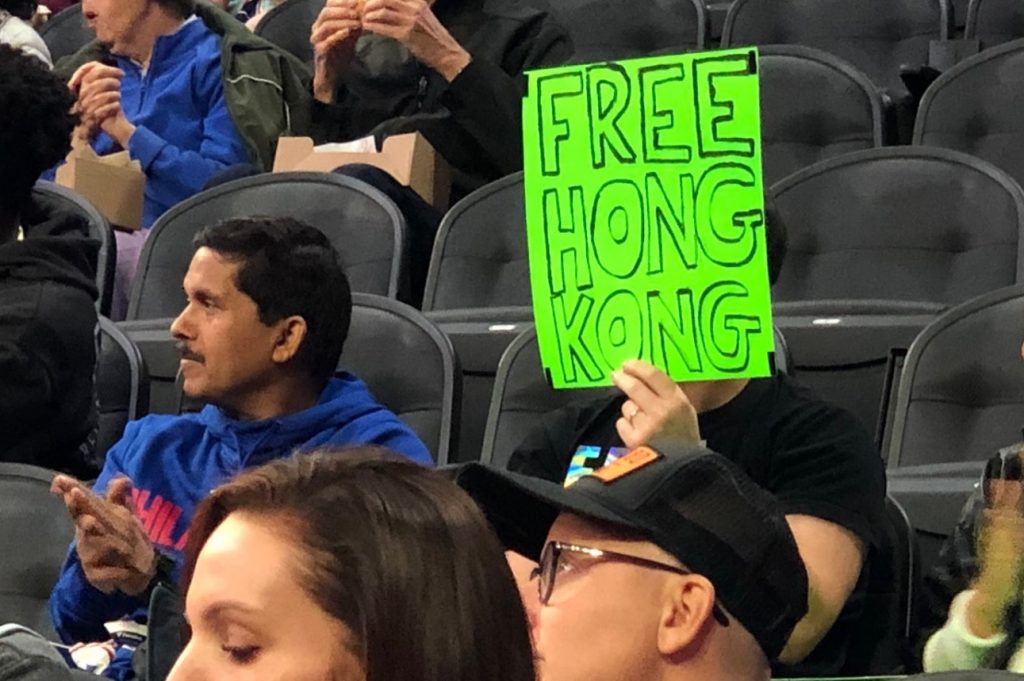 Resized_SixersProtest-_Sam_Only Sam Wachs holds a sign that reads 'Free Hong Kong' at the Sixers pre-season game. (Courtesy of Sam Wachs)