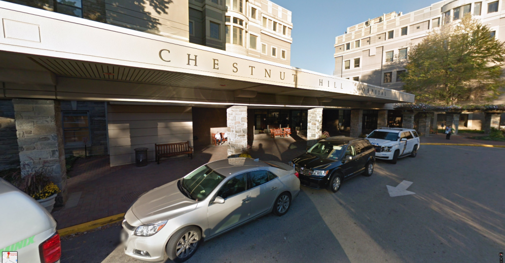 Screen Shot 2019-10-15 at 6.28.28 PM Chestnut Hill Hospital entrance with cars in front of it.