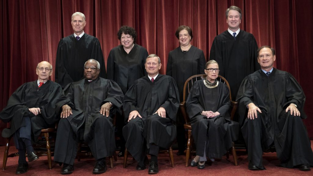 The Supreme Court justices, pictured in November 2018, start a new term on Monday. (J Scott Applewhite/AP)
