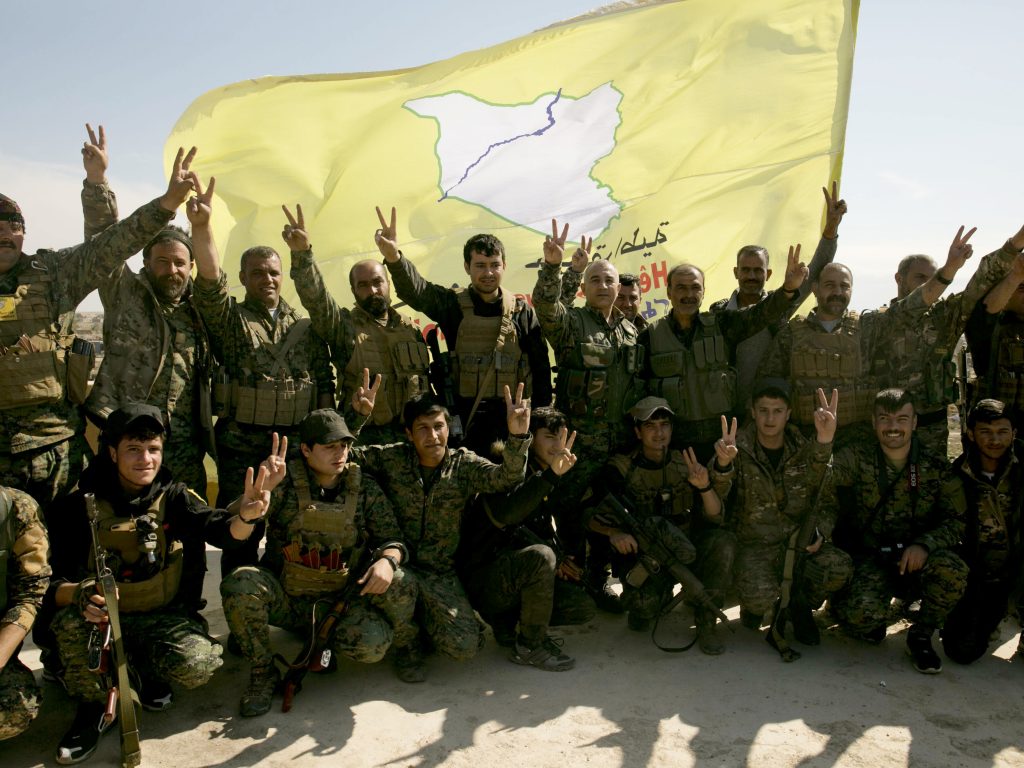U.S.-backed Syrian Democratic Forces (SDF) fighters pose for a photo in Baghouz, Syria, after the SDF declared the area free of Islamic State militants, in March. U.S.-backed Syrian Democratic Forces (SDF) fighters pose for a photo in Baghouz, Syria, after the SDF declared the area free of Islamic State militants, in March. (Maya Alleruzzo/AP)