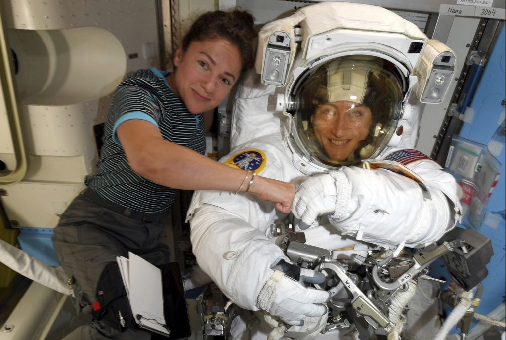 Astronauts Christina Koch (right) and Jessica Meir pose for a photo on the International Space Station on Oct. 4. NASA moved up the first all-female spacewalk because of a power system failure at the space station. Astronauts Christina Koch (right) and Jessica Meir pose for a photo on the International Space Station on Oct. 4. NASA moved up the first all-female spacewalk because of a power system failure at the space station. (NASA via AP)