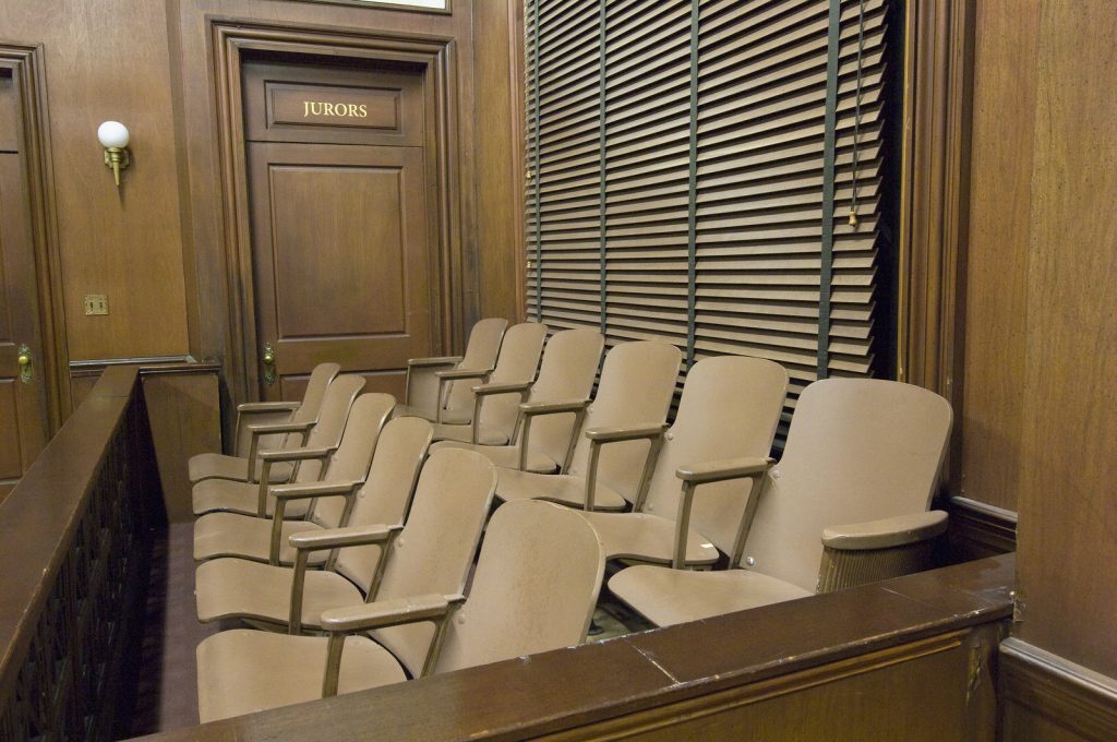 Side view of a empty jury box in the courthouse (Nosnibor137/Bigstock)